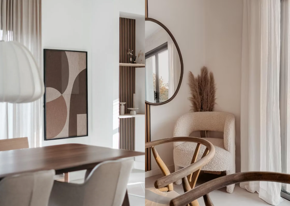 Espace de vie nordique minimaliste avec des tons neutres, un panneau de bois acoustique Akupanel comme art mural, un miroir rond, une chaise dappoint beige, une table de salle à manger en bois et un centre de table en herbe de la pampa.