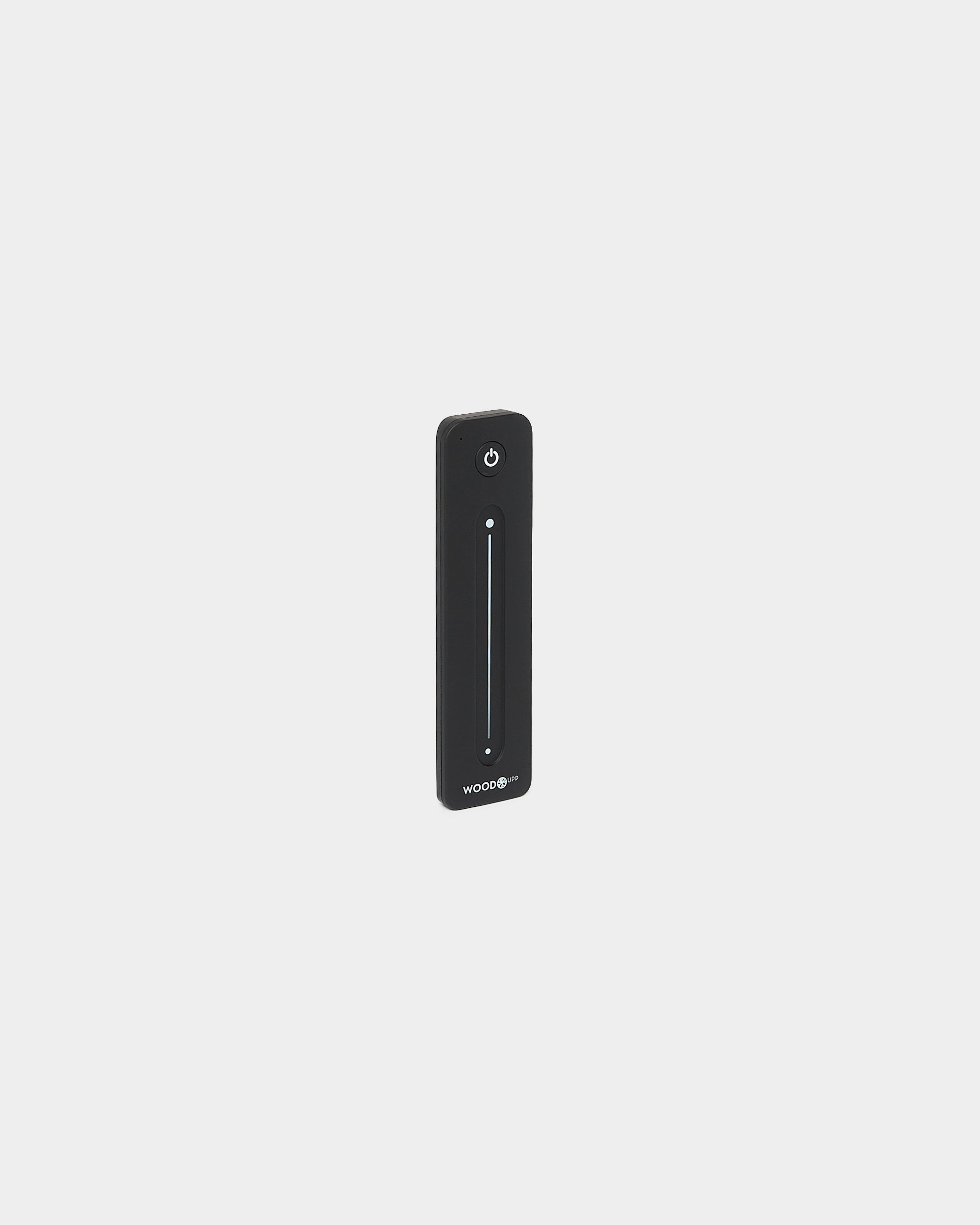 Télécommande WoodUpp black fine pour rubans LED Lumi, avec curseur tactile vertical et bouton marche/arrêt, compatible Philips Hue, présentée sur fond blanc.
