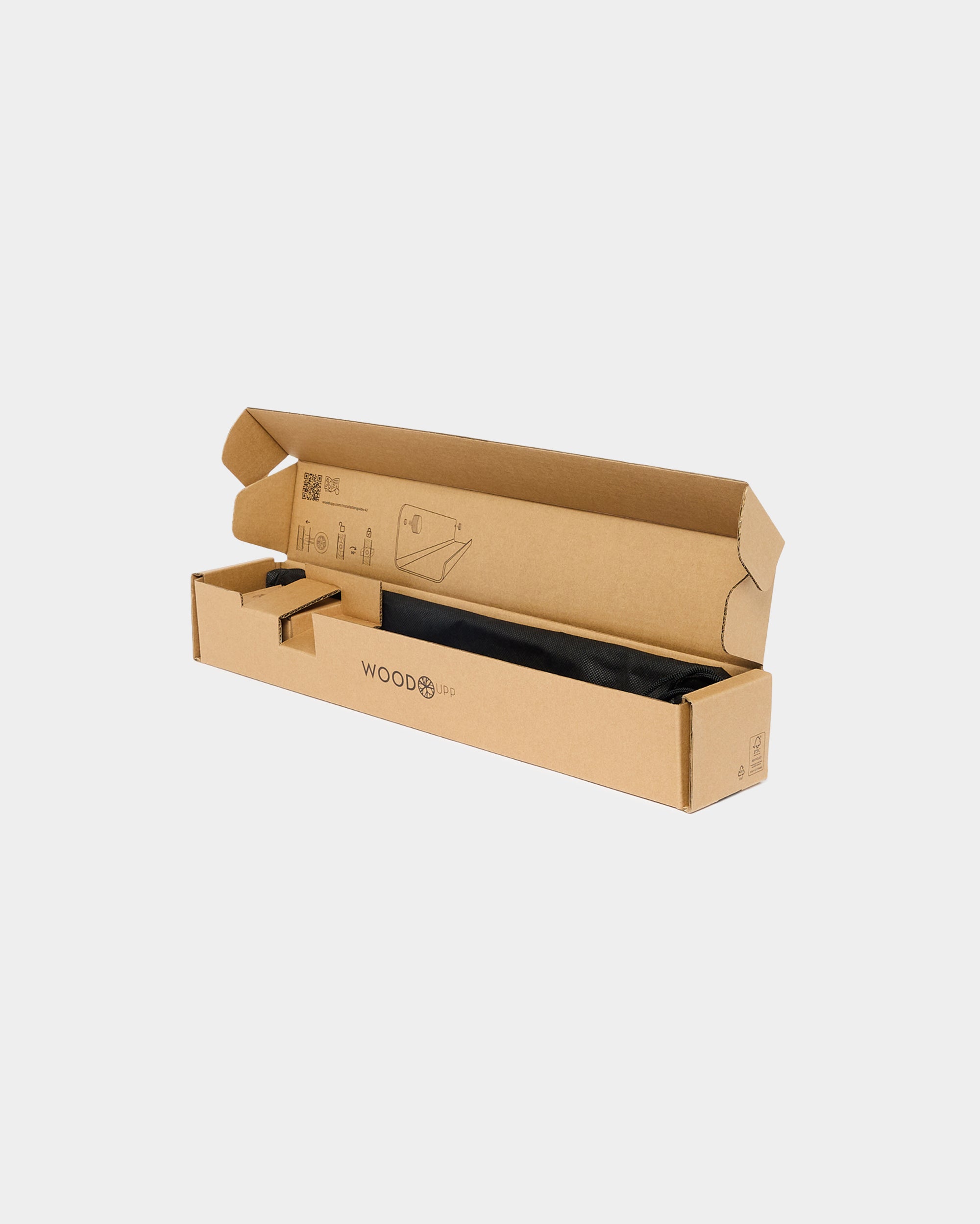 A brown WOODS cardboard box with its lid open displays a black acoustic panel inside, set against a plain white background.